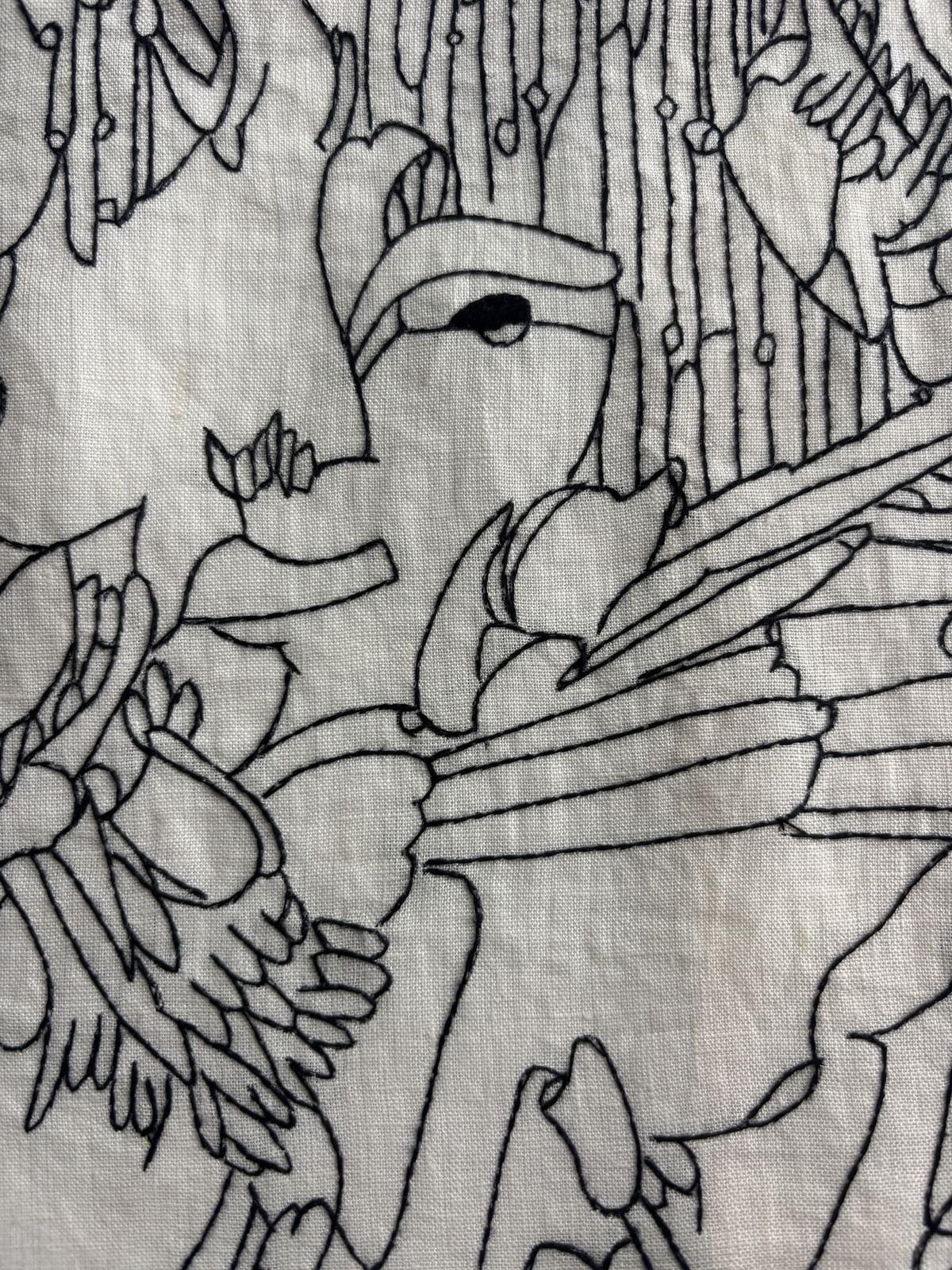 Close detail of black-thread stitching, layered contours