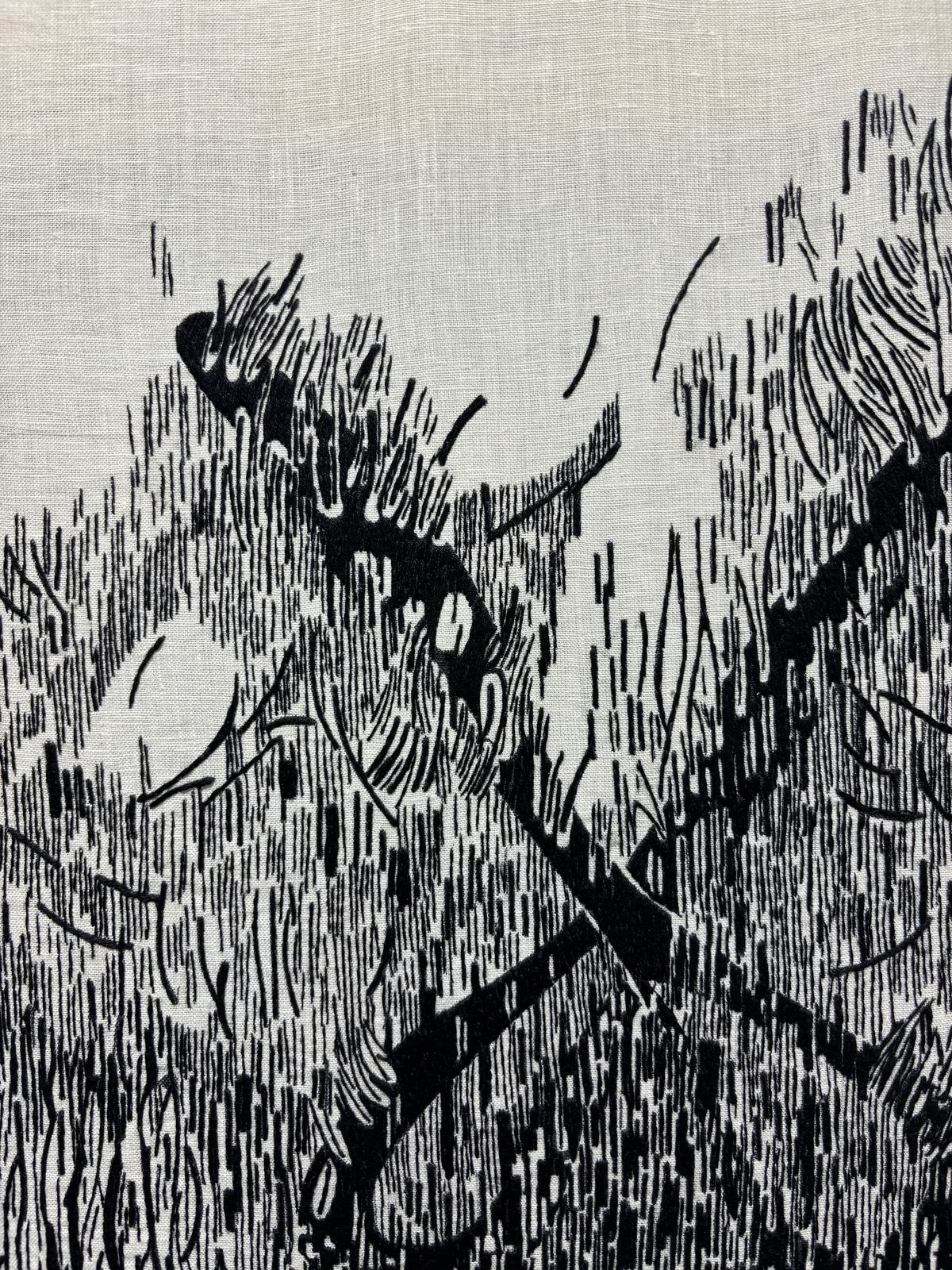 Close detail of black-thread stitching, crossed branch-like lines